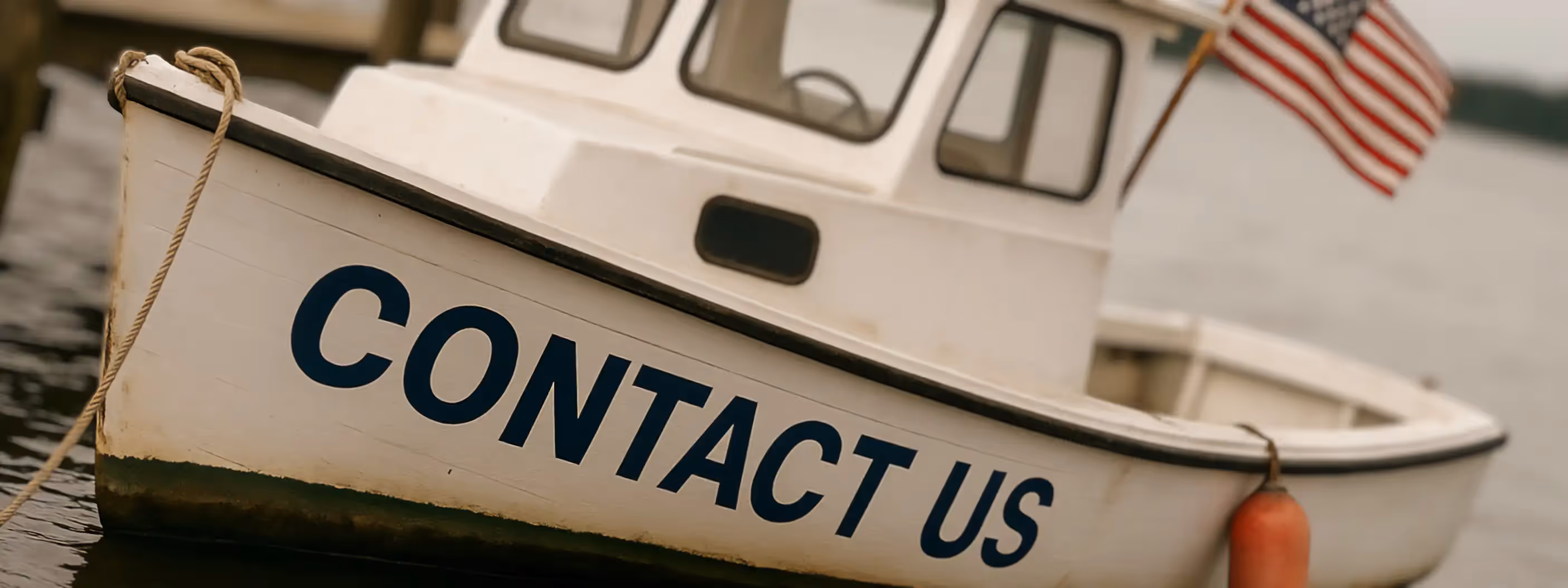 A boat at sea with the label contact us painted on it