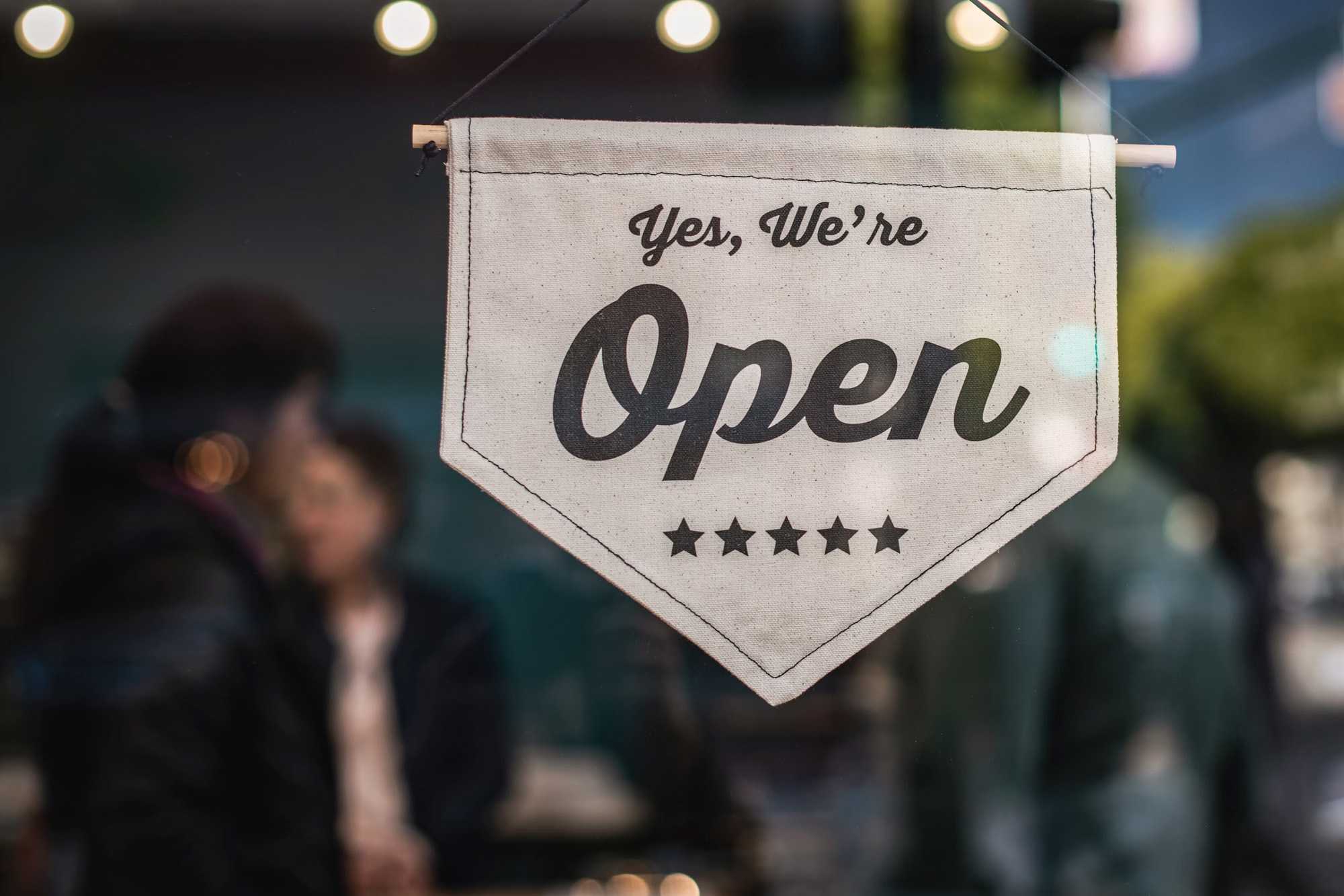 A local shop with an open sign on the door