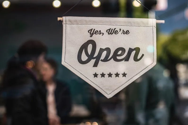A local shop with an open sign on the door