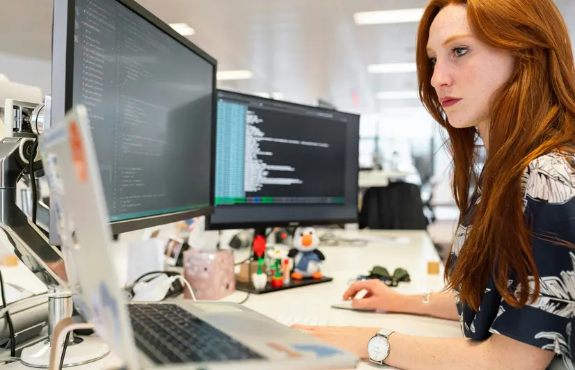 A woman at a computer performing on-page SEO.